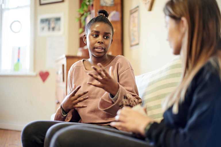 Behavioral psychologist speaking to young girl