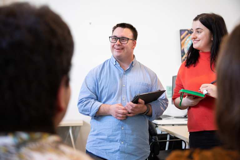 Man hosts meeting beside his rehabilitation counselor
