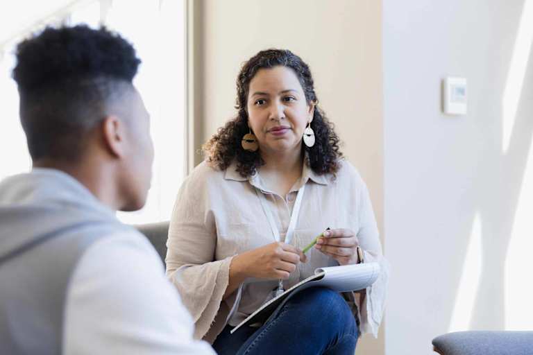 Social worker speaking to young adult
